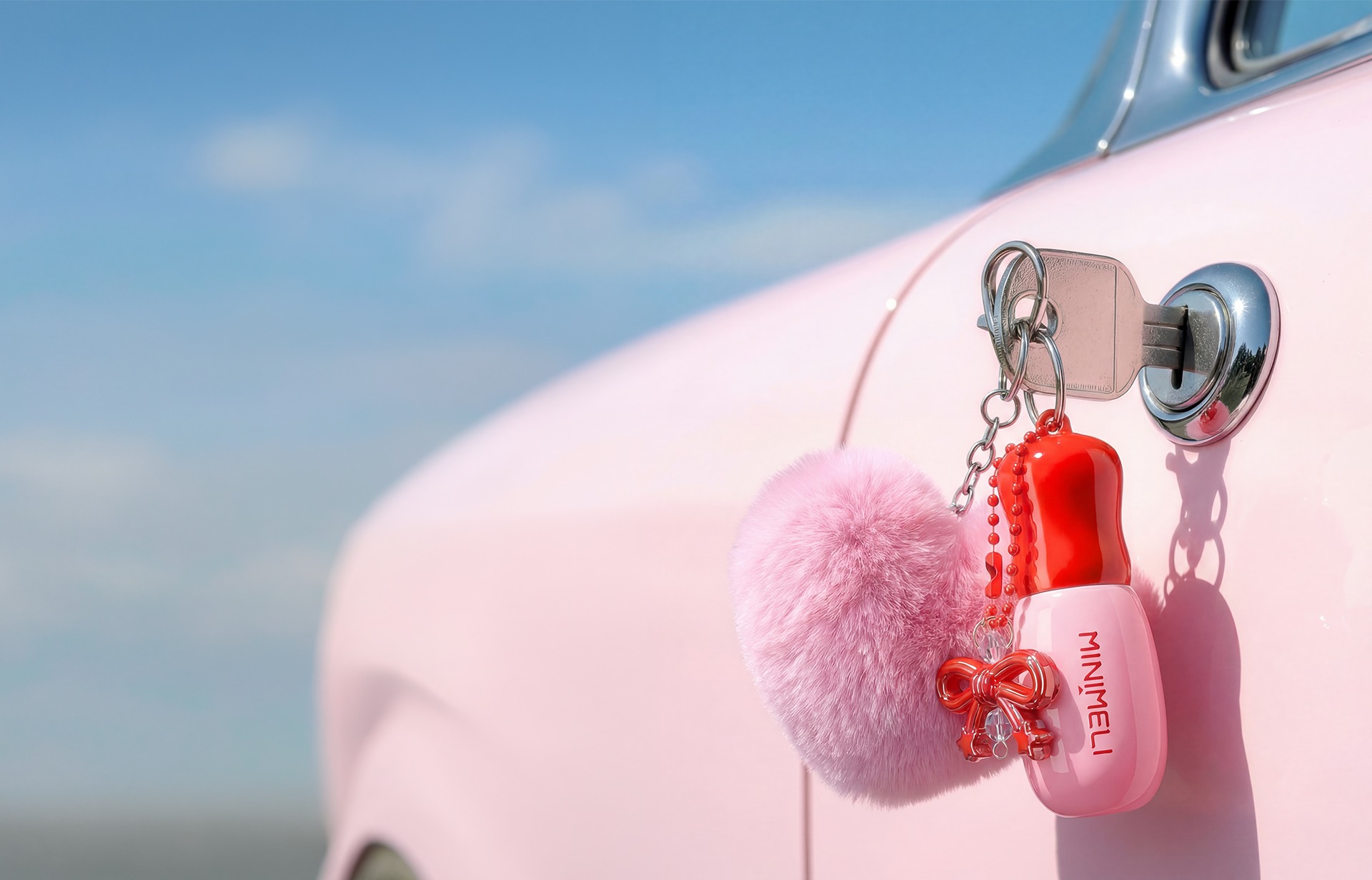 MINIMELI charm hanging on a pink car door